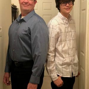 two men nicely dressed standing back to back