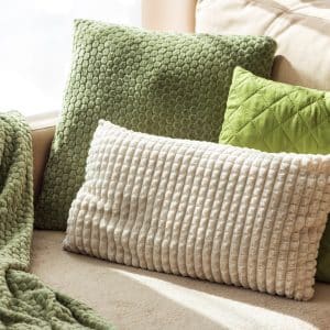 Textured Pillows and Blanket on Cozy Beige Sofa