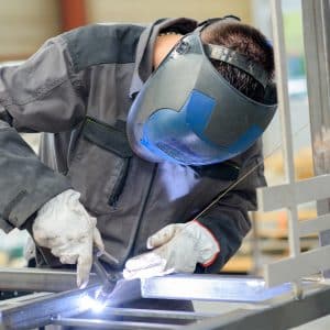 welder actively welding a piece of metal