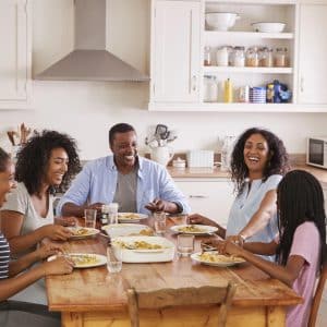 Family with Teenage Children Eating Meal in Kitchen