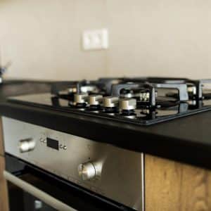 black gas stove and black kitchen countertop