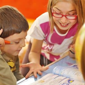 kids doing homework at a table