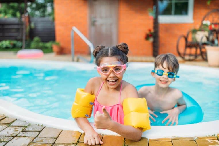 children in a family pool on a summer day