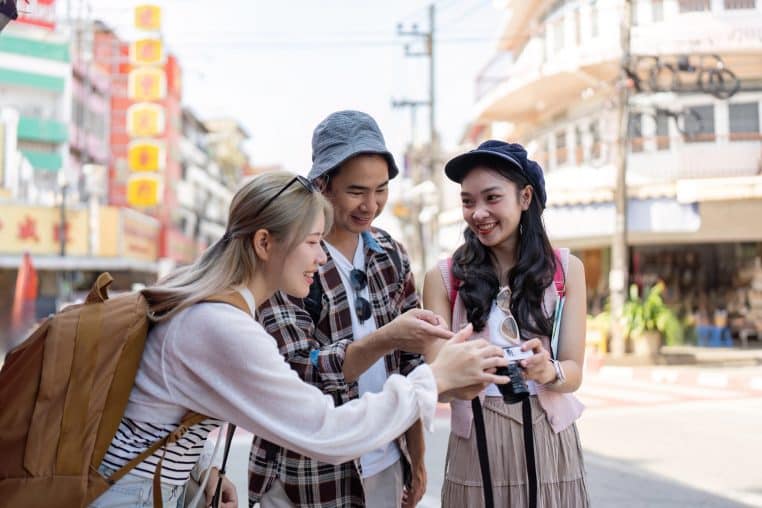 group of young tourists all looking at the viewer side of a camera