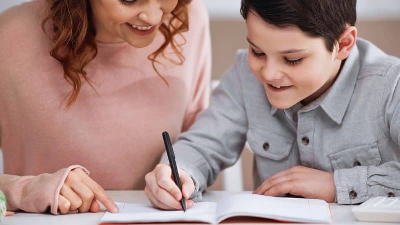 mother and son doing homework together