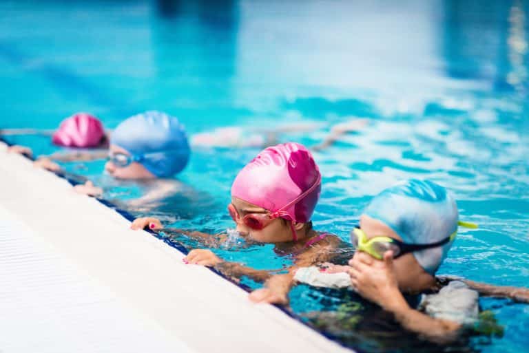Group of children on swimming class, making bubbles