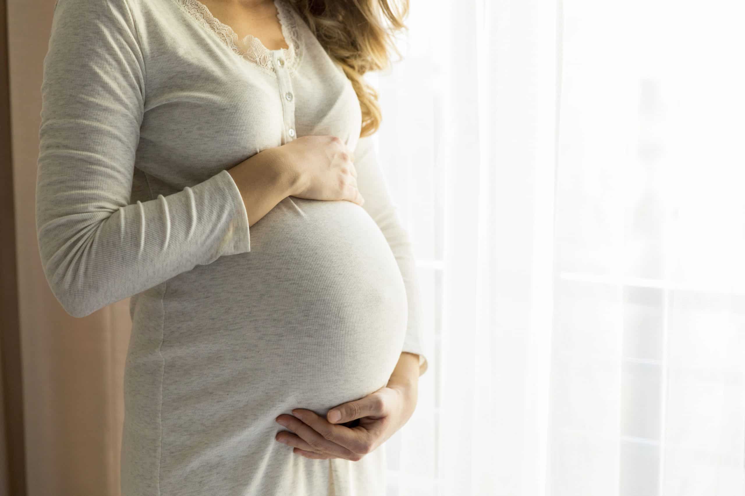 Young pregnant woman in bedroom