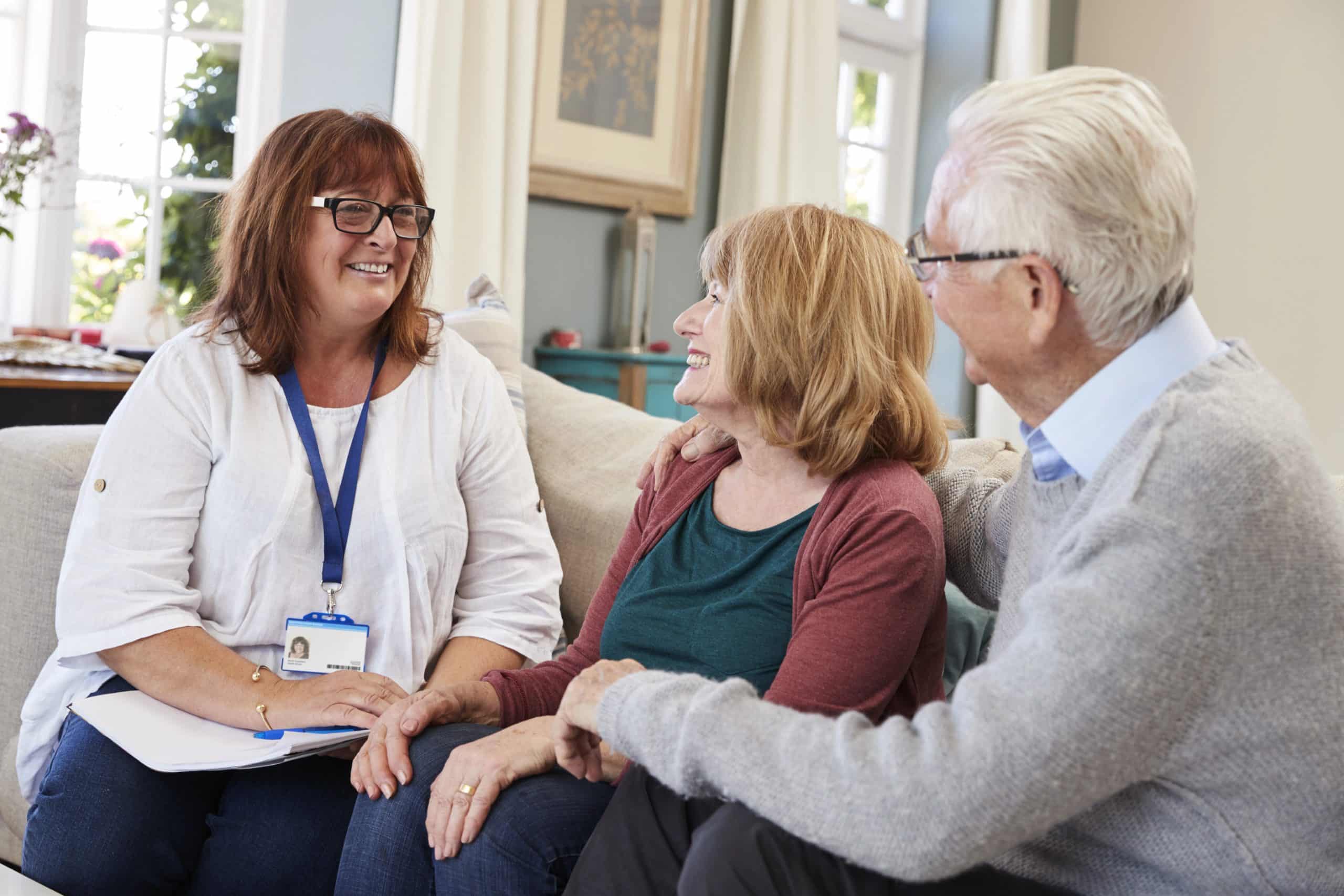 Female Support Worker Visits Senior Couple At Home Support Worker Visits Senior Couple